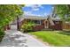 Charming brick home with a well-manicured lawn and a quaint front entrance at 7192 W 67Th Pl, Arvada, CO 80003