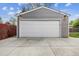 Close-up of detached garage with a white door, providing secure parking at 7192 W 67Th Pl, Arvada, CO 80003