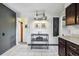 Hallway area with tile flooring, decorative lighting fixture, and chalkboard accent at 7192 W 67Th Pl, Arvada, CO 80003