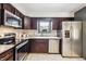 Kitchen featuring stainless appliances, undermount sink and dark cabinetry at 7192 W 67Th Pl, Arvada, CO 80003