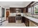 Well-equipped kitchen featuring stainless steel appliances and dark wood cabinetry at 7192 W 67Th Pl, Arvada, CO 80003