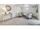 Cozy living room featuring plush gray carpet, four armchairs, and a classic wall clock at 7192 W 67Th Pl, Arvada, CO 80003