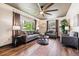 Cozy living room with hardwood floors, large windows, and stylish furnishings at 7192 W 67Th Pl, Arvada, CO 80003
