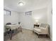 Home office space featuring a modern desk, comfortable chair, and two windows at 7192 W 67Th Pl, Arvada, CO 80003