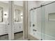 Well-lit bathroom featuring a shower over a tub and dual vanities with modern fixtures at 918 Dakota Dr, Castle Rock, CO 80108