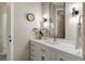 Bright bathroom features white vanity, stylish fixtures, wall clock, and decorative vase at 918 Dakota Dr, Castle Rock, CO 80108