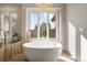 An elegant bathroom offers a freestanding tub with large window providing natural light and views at 918 Dakota Dr, Castle Rock, CO 80108