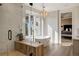 A luxurious bathroom with a glass-enclosed shower, soaking tub, and stylish chandelier at 918 Dakota Dr, Castle Rock, CO 80108