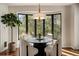 Bright dining room with round table and chairs, a modern chandelier, and a large window view at 918 Dakota Dr, Castle Rock, CO 80108