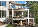 Beautiful home exterior with multiple decks, patio, black railings, and forest views at 918 Dakota Dr, Castle Rock, CO 80108