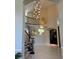 Grand foyer with soaring ceilings, statement lighting, and a curved staircase with iron railings at 918 Dakota Dr, Castle Rock, CO 80108