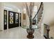 Elegant foyer featuring marble floors, a decorative table, and a grand entry door with custom glass design at 918 Dakota Dr, Castle Rock, CO 80108