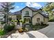 Elegant two-story home features a landscaped front yard, manicured garden beds, and driveway at 918 Dakota Dr, Castle Rock, CO 80108