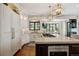 Modern kitchen featuring marble countertops, stainless steel appliances, and custom cabinetry with a dark island at 918 Dakota Dr, Castle Rock, CO 80108