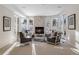 Sun-filled living room with a fireplace, four chairs, and large windows with winter view at 918 Dakota Dr, Castle Rock, CO 80108