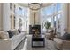 Bright living room with large windows, a fireplace, comfortable seating, and a stylish rug at 918 Dakota Dr, Castle Rock, CO 80108