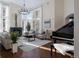 Inviting living room featuring large windows, hardwood floors, a fireplace, and a grand piano at 918 Dakota Dr, Castle Rock, CO 80108