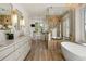 Modern bathroom with dual vanities, freestanding tub, walk-in shower, and natural light at 918 Dakota Dr, Castle Rock, CO 80108