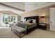 Luxurious primary bedroom featuring a tray ceiling, bench, and a seating area with natural light at 918 Dakota Dr, Castle Rock, CO 80108