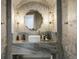 Elegant powder room featuring textured walls, modern lighting, round sink, and gray marble countertop at 918 Dakota Dr, Castle Rock, CO 80108