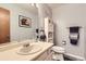 Bathroom featuring a white vanity, a large mirror, and a toilet with storage cabinet at 3680 S Gibralter Cir, Aurora, CO 80013