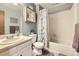 Traditional bathroom featuring a shower-tub combination, vanity, and neutral color palette at 3680 S Gibralter Cir, Aurora, CO 80013