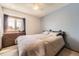 Cozy bedroom with a bed, dresser, window, and soft neutral tones at 3680 S Gibralter Cir, Aurora, CO 80013