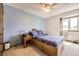 Cozy bedroom with a ceiling fan, carpeted floor, and a large window at 3680 S Gibralter Cir, Aurora, CO 80013