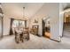 Cozy dining area with wood furnishings, a chandelier, and natural light from the adjacent window at 3680 S Gibralter Cir, Aurora, CO 80013