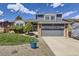 Charming home showcasing a well-maintained front yard, complemented by blue accents and a two-car garage at 3680 S Gibralter Cir, Aurora, CO 80013