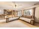Spacious living room featuring neutral carpet, large windows, and an open staircase to the dining area at 3680 S Gibralter Cir, Aurora, CO 80013