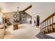 Bright living room with neutral carpet, ceiling fan, and stairs to the second floor at 3680 S Gibralter Cir, Aurora, CO 80013