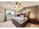 Comfortable main bedroom featuring a large bed with drawer storage and windows for natural light at 3680 S Gibralter Cir, Aurora, CO 80013
