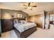 Comfortable main bedroom featuring a large bed, ceiling fan, and closets for storage at 3680 S Gibralter Cir, Aurora, CO 80013