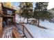 Deck overlooks snowy backyard with storage shed at 20242 Cypress Dr, Morrison, CO 80465