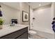 Well-lit bathroom with a modern vanity, a bathtub, and white tiled walls at 903 W Beverly St, Elizabeth, CO 80107