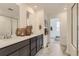 Well-lit bathroom featuring double sinks, neutral tile floors, and glass shower at 903 W Beverly St, Elizabeth, CO 80107