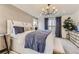 Bright bedroom with stylish light fixture, large window and neutral tones at 903 W Beverly St, Elizabeth, CO 80107