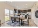 Bright dining area with stylish table and chairs, adjacent to the kitchen and a sliding glass door at 903 W Beverly St, Elizabeth, CO 80107