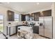 Modern kitchen featuring stainless steel appliances and dark cabinets at 903 W Beverly St, Elizabeth, CO 80107
