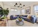 Bright living room with a plush sectional sofa and decorative lighting fixtures at 903 W Beverly St, Elizabeth, CO 80107