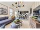 Open-concept living space with modern furnishings and adjacent kitchen at 903 W Beverly St, Elizabeth, CO 80107