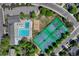 Aerial view of community amenities including pool, tennis courts, volleyball court, and parking at 10289 E Berry Dr, Greenwood Village, CO 80111