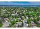 Aerial view of the beautiful surrounding community featuring lush green trees with distant lake view at 10289 E Berry Dr, Greenwood Village, CO 80111