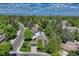 Aerial view of neighborhood with mature trees and mountain views in the background at 10289 E Berry Dr, Greenwood Village, CO 80111