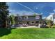Spacious backyard featuring a stone patio, outdoor seating, and a well-manicured lawn at 10289 E Berry Dr, Greenwood Village, CO 80111