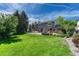 Large backyard featuring an outdoor seating area and mature trees providing ample shade and privacy at 10289 E Berry Dr, Greenwood Village, CO 80111