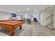 Finished basement featuring an open floorplan, pool table, entertainment area, and stylish decor at 10289 E Berry Dr, Greenwood Village, CO 80111