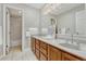 Bathroom features double sinks, neutral tile floors, and a shower with a tub at 10289 E Berry Dr, Greenwood Village, CO 80111