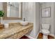 Stylish powder room with granite countertop, vessel sink, and modern fixtures at 10289 E Berry Dr, Greenwood Village, CO 80111